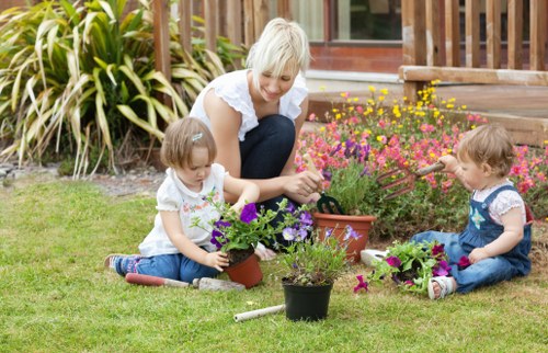 Gardener taking payment details on tablet for Morden services